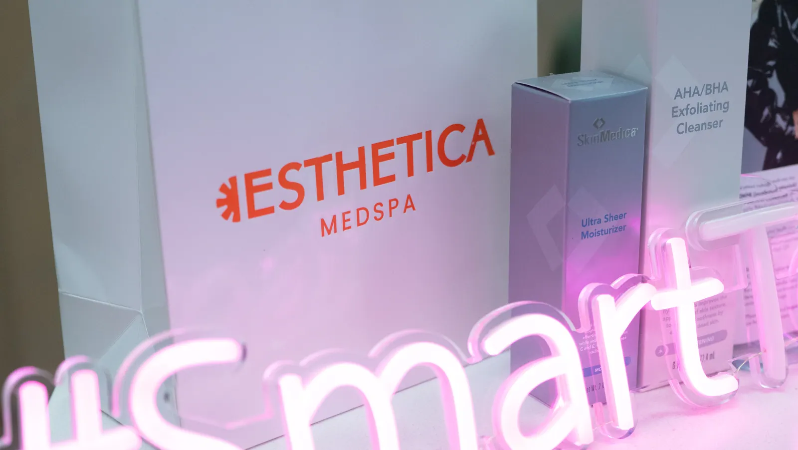 The Esthetica MedSpa neon sign glowing pink