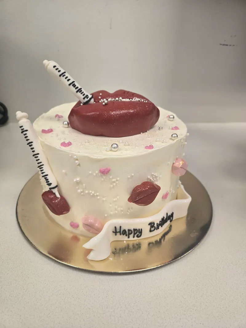 A custom lip-and-syringe cake at a Botox & Bubbles event