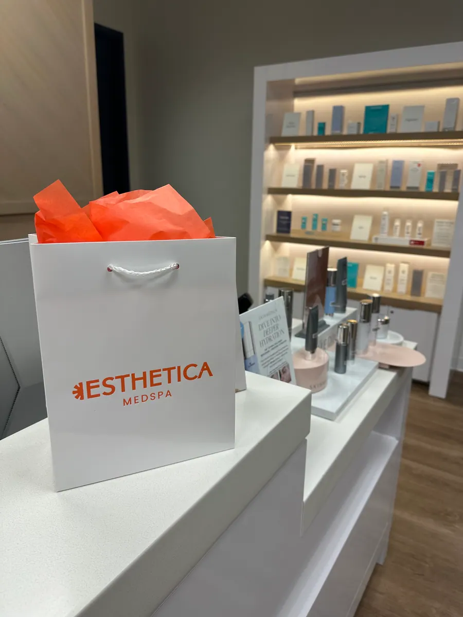 An Esthetica MedSpa retail bag on the skincare shelf