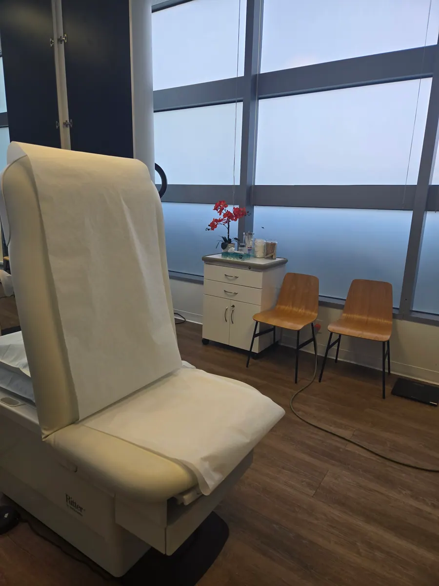 A private treatment room with Tampa Bay skyline through floor-to-ceiling windows