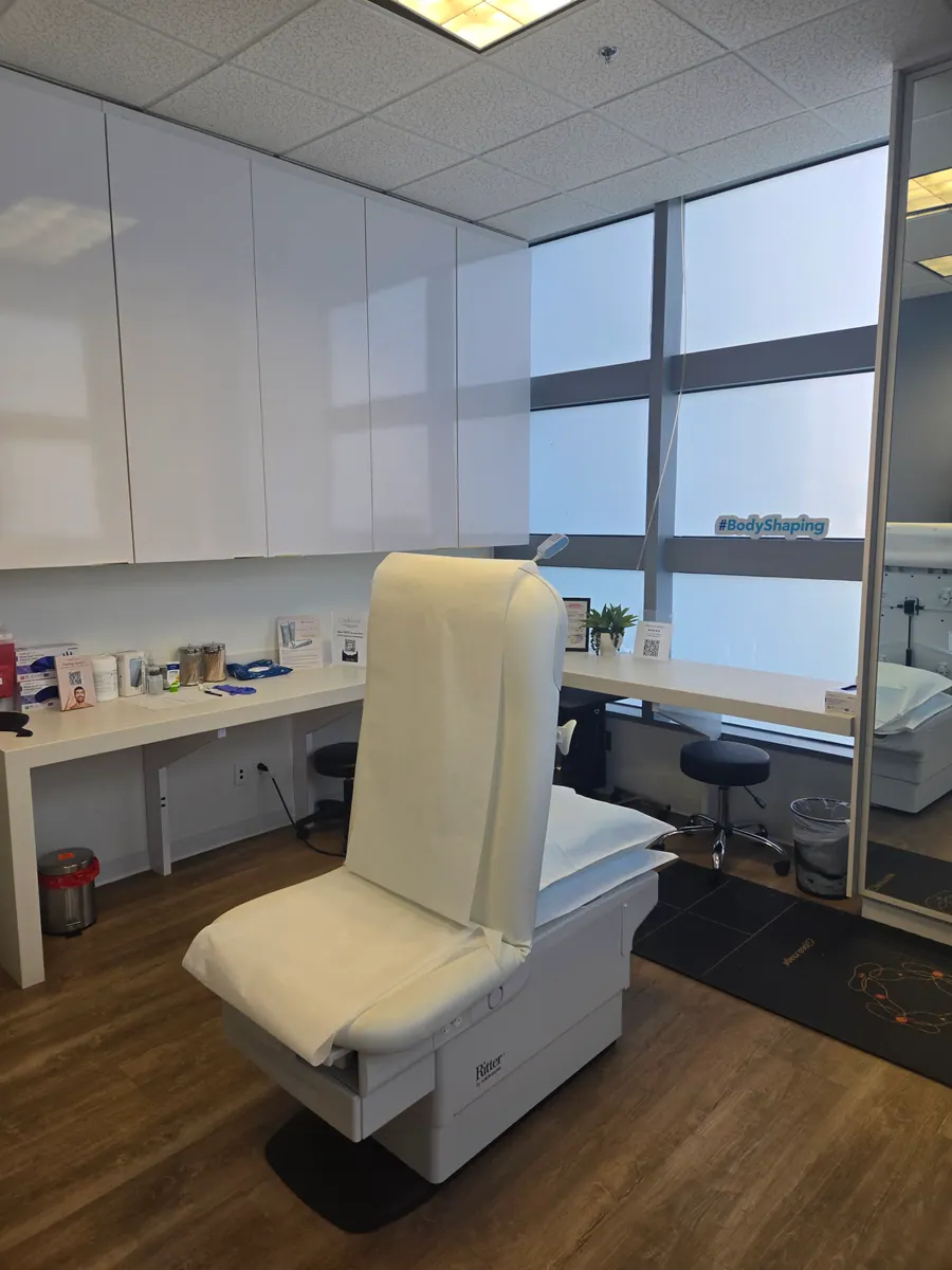 Treatment chair and clinician station beside bright bay windows